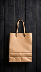 Simple brown paper shopping bag with thick rope handle resting on a dark wooden surface