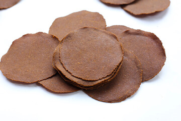 Fermented soybean discs, known as “Thua Nao,” a traditional Thai seasoning used to enhance flavor in Northern cuisine.