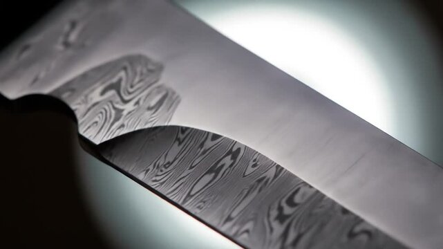 Close up detailed views of damascus steel knife blades revealing intricate patterns and sharp