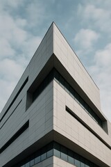 Modern architectural building with geometric design against cloudy sky
