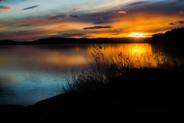 Sunset reflects on early winter ice on Lake Auburn, Auburn Maine.  