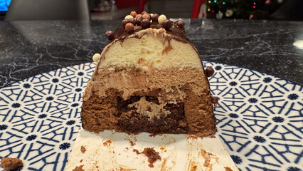 Cross-section of a layered triple chocolate mousse cake for a festive holiday celebration