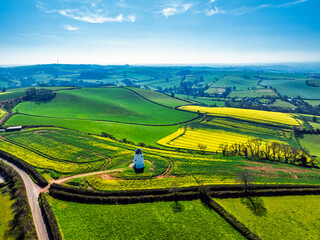 Rapeseed fields and Farms over Devon Windmill from a drone, Torquay, Devon, England