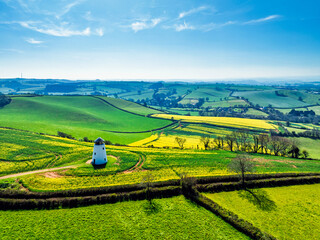 Rapeseed fields and Farms over Devon Windmill from a drone, Torquay, Devon, England