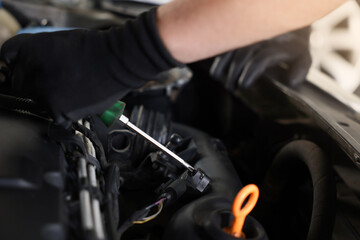 Auto parts. Professional mechanic with screwdriver fixing car indoors, closeup
