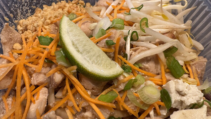 Close-up of fresh ingredients on a Chicken Pad Thai takeout meal 
