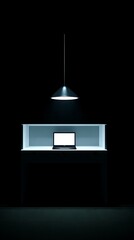 Illuminated laptop on a display case in a dark room.