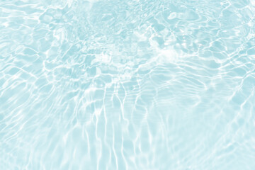 Blue water with ripples on the surface. Defocus blurred transparent blue colored clear calm water surface texture with splashes and bubbles. Water waves with shining pattern texture background.