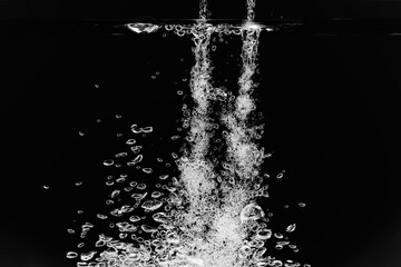 黒の背景に水中に舞い上がるたくさんの気泡.
