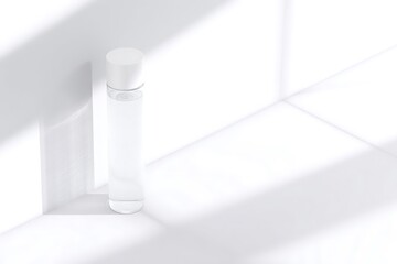 Empty cylindrical bottle on a white surface.