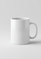 Obraz premium Clean white ceramic mug mockup with subtle shadow on white background