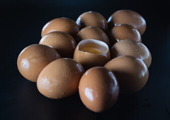 View of Egg yolk in Broken raw chicken eggshell in the among of Fresh chicken egg (Hen egg) on...