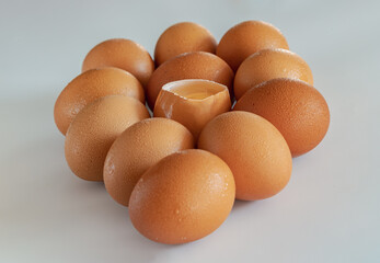 View of Egg yolk in Broken raw chicken eggshell in the among of Fresh chicken egg (Hen egg) on...