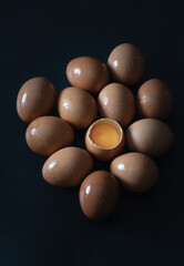 Top view of Egg yolk in Broken raw chicken eggshell in the among of Fresh chicken egg (Hen egg) on...