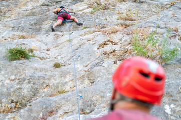 Climbers Ascending a Steep Rocky Cliff Face