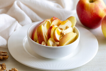 Healthy vegetarian Salad with apples, walnuts and honey in bowl