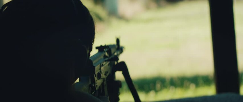 Silhouette of shooter aiming at outdoor range during shooting training