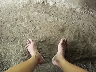 Bare Feet on Textured Dirt Ground Overhead View