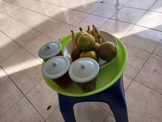 Indonesian Tropical Fruits and Drinks on Plastic StoolIndonesian Tropical Fruits and Drinks on...