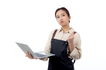 Portrait young asian business woman wearing apron holding laptop computer isolated white background, waitress or barista holding laptop computer while thoughtful, cut out, business or freelance.