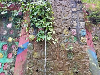 Water Flowing Down Colorful Textured Stone Wall