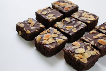 Set group Chocolate Brownies piece with topping almond slice on white background. Side view