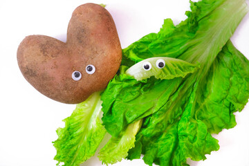 Cute potato and green lettuce with googly eyes, cartoon couple. Humor. Creativity, individuality.  White background