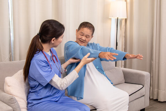 Senior patient doing arm stretching exercise with nurse in home setting, smiling and engaging in active elderly wellness session with support and care, healthcare, caregiver, take care, medical. - Powered by Adobe