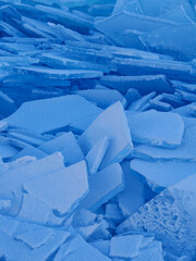 Endless hummock field on frozen Lake Baikal. Piles of snow-covered debris of blue ice on frosty day