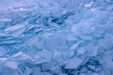Endless hummock field on frozen Lake Baikal. Piles of snow-covered debris of blue ice on frosty day