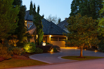 Two story stucco luxury house with nice Spring blossom landscape at night in Vancouver, Canada,...