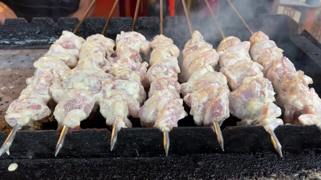 Different types of Reshmi kabab getting roasted in skewers in Kolkata, India