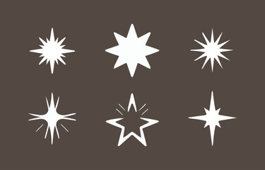 Fototapeta premium A collection of six unique white starburst and sparkle graphic elements with sharp points and glowing effects displayed against a dark brown background