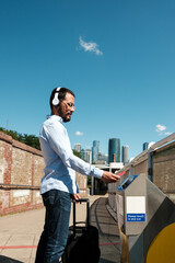Businessman validating train ticket at station using modern electronic gate