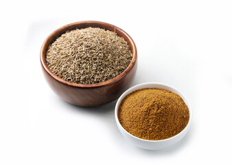 Indian seeds or spices called cumin seed and cumin powder in bowl isolated on white background 
