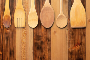 Wooden Kitchen Utensils on Rustic Wooden Surface in Natural Light. File with Clipping Path.