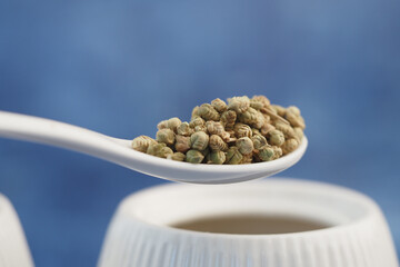 chamomile seeds on spoon ready for culinary use in kitchen