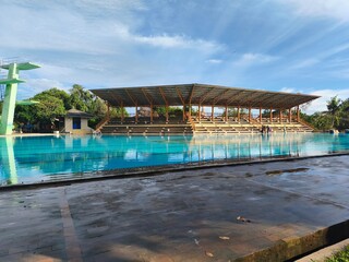swimming pool with a backdrop of diving board and spectator stands