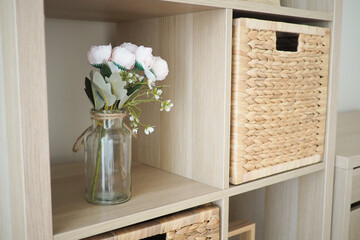 Decorative arrangement of flowers and baskets on a shelf