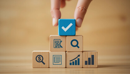 Hand placing blue cube check mark on wooden block