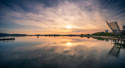 Tranquil Sunset Reflections Over a Calm Lake in Nature's Embrace