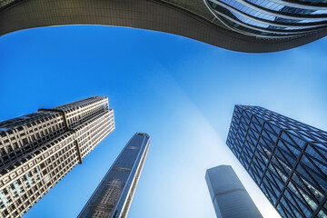 Stunning Low-Angle Perspective of Modern Skyscrapers Against a Clear Blue Sky