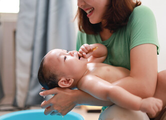Baby's morning routine, cleaning baby and infant in the bath, hygiene, health or wellness with...