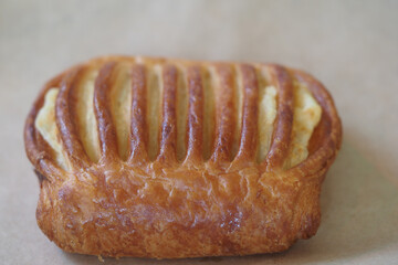Golden pastry with perfect baked lines sits on a surface