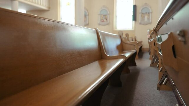 Moving through the wooden church pews of a catholic church on a Sunday morning.