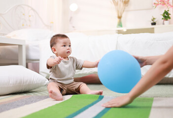 Mother and son playing with balloons, happy family