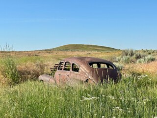 old abandoned car on rural land 