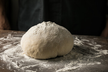 Obraz premium Elderly Hands Kneading Dough for Homemade Bread