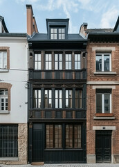 Fototapeta premium Charming house featuring wooden window frames and white walls