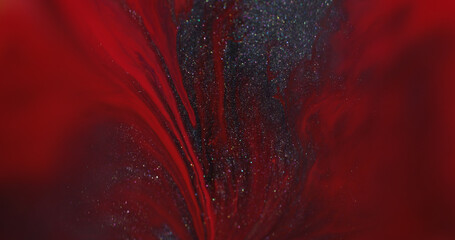 Drip art. Spill texture. Defocused red silver color ink splash sparkling particles spreading on...